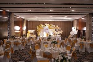 a banquet hall with white tables and chairs and a cake at Sky City Hotel Dhaka in Dhaka +81 photos
