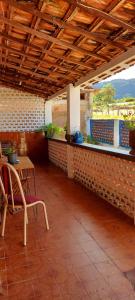 a patio with a table and a table and a chair at Contos de Alice in Tiradentes