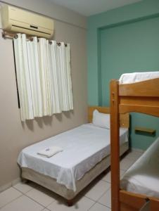 a bedroom with two bunk beds and a window at Marina Hotel in Ciudad del Este