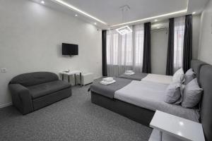 a hotel room with a bed and a chair at DavidL Hotel Tbilisi in Tbilisi City