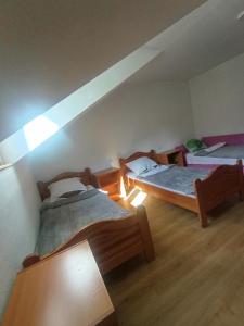 a room with two beds in a attic at Anika apartmani in Tjentište