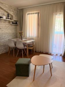 a living room with a table and chairs and a dining room at Mivasto Sea View in Risan +10 photos
