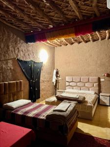 a bedroom with two beds in a room at Gite d étape Khettara Oasis in Er Rachidia