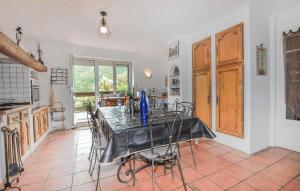 a kitchen and dining room with a table and chairs at Awesome Home In Rigarda in Rigarda