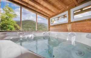 a bath tub with a view of a mountain at Awesome Home In Rigarda in Rigarda