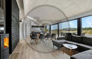 a living room with a couch and a fireplace at Awesome Home In Jerup With Sauna in Jerup