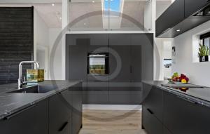 a kitchen with gray cabinets and a sink at Awesome Home In Jerup With Sauna in Jerup