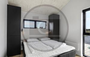a bedroom with a large bed with a mirror at Awesome Home In Jerup With Sauna in Jerup +5 photos