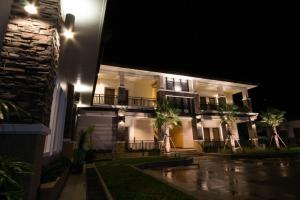 a house at night with rain on the street at Fortune Surin Hotel in Surin