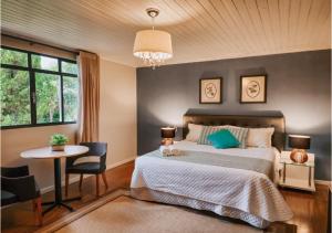 a bedroom with a bed and a table and a window at Hotel Sonnet Curitiba in Curitiba +53 photos
