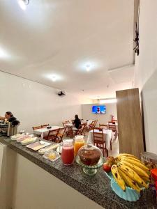 a table with food on a counter in a restaurant at Pousada Lua Bela in Piranhas