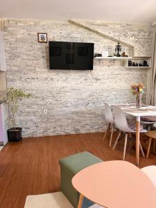 a living room with a tv on a brick wall at Mivasto Sea View in Risan