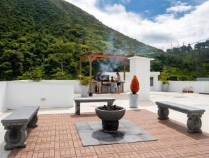 a group of people sitting at a table on a patio at CarDiem Suites in Baños