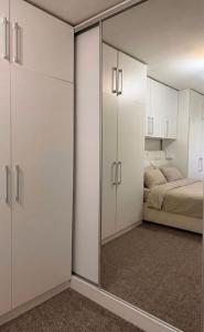 a bedroom with a large mirror and a bed at Mivasto Sea View in Risan