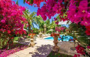 a garden with pink flowers and a swimming pool at Santa Lucia in Binissalem