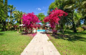 a walkway in a park with pink flowers at Santa Lucia in Binissalem +54 photos