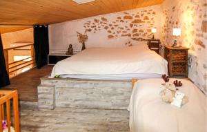 a bedroom with two beds and two teddy bears sitting on them at Mazet Du Gua in La Pervenche