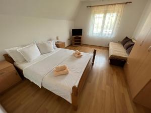 a bedroom with a large bed with two towels on it at Vila Simic in Soko Banja