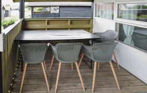 a table and four chairs on a balcony with a table at Lovely Apartment In Farsø in Farsø