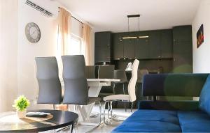 a living room with a couch and a table and chairs at Amazing Home In Dugobabe in Dugobabe