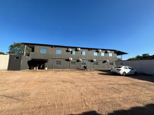 a building with a car parked in front of it at Fênix Hotel Colinas do Tocantins in Colinas do Tocantins