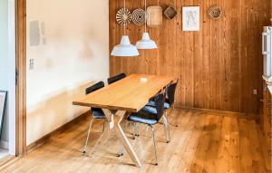 a wooden table in a room with chairs at 3 Bedroom Stunning Home In Bedsted Thy in Bedsted Thy