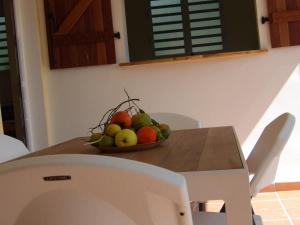 a bowl of fruit sitting on a table at LAPALOMADESANSEs in Les Anses-dʼArlets