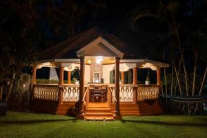 a small gazebo with a porch at night at Naibor Villa Arusha in Arusha