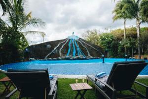 a large swimming pool with a tent in the background at Naibor Villa Arusha in Arusha