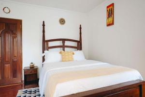 a bedroom with a large bed with a wooden headboard at Naibor Villa Arusha in Arusha