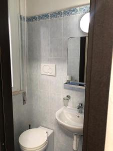 a small bathroom with a toilet and a sink at Hotel Continental in Pesaro +13 photos