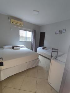 a hotel room with two beds and a window at Fênix Hotel Colinas do Tocantins in Colinas do Tocantins +33 photos