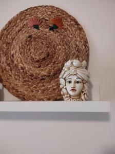 a basket and a statue on a shelf at Elena 's HOME in Conversano