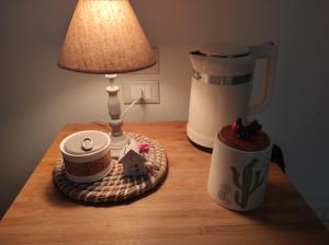 a table with a lamp and a cup of coffee and a house on it at Elena 's HOME in Conversano +21 photos