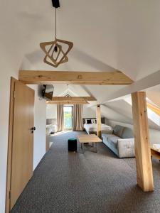 a room with a loft with a bed and a table at Silence in Zator