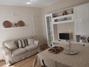 a living room with a couch and a table at Elena 's HOME in Conversano