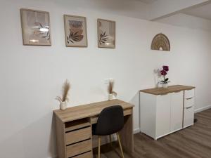 an office with a desk and a chair and pictures on the wall at Cosy home in Saint Martin