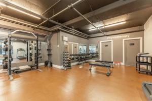 a gym with a row of treadmills and machines at Spectacular Penthouse With Amazing Views, Indoor Pool and Hot tub in Canmore