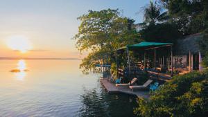 a group of chairs sitting on a dock next to the water at Mayan Spirit in Flores