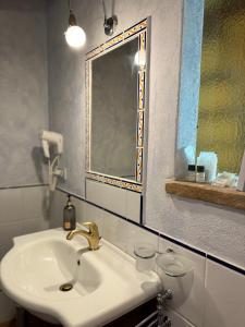 a bathroom with a sink and a mirror at Pienzalettings "Suites" in Pienza +115 photos