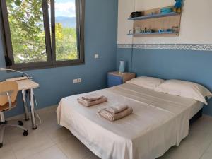a bedroom with a bed with two towels on it at Sea & Summit Pool Villa in Platamonas