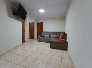 a living room with a couch and a flat screen tv at Departamentos Don Julio in Guaraní