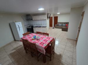 a kitchen and dining room with a table and chairs at Departamentos Don Julio in Guaraní