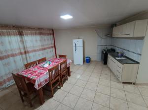 a kitchen with a table and chairs and a refrigerator at Departamentos Don Julio in Guaraní +4 photos