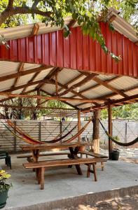 a hammock on a picnic table in a park at Tuncosurfhouse in El Sunzal +14 photos