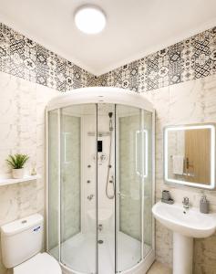 a bathroom with a shower and a toilet and a sink at Modern Comfort Stay Tanger in Tangier +7 photos