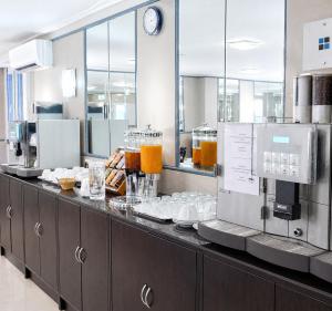 a kitchen with a counter with food on it at Hotel Donaustadt Kagran - at Metro U1 in Vienna