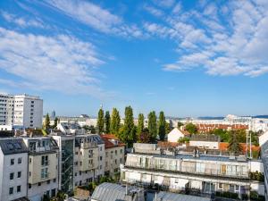 a view of a city with buildings and trees at Hotel Donaustadt Kagran - at Metro U1 in Vienna