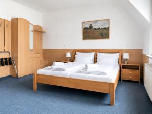 a bedroom with a bed with white sheets and pillows at Hotel Donaustadt Kagran - at Metro U1 in Vienna +17 photos