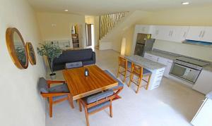 a living room with a table and a kitchen at Departamentos VESA in Ajijic +9 photos